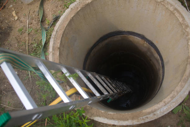 istock The staircase is lowered into a deep well made of concrete rings. 1266139986