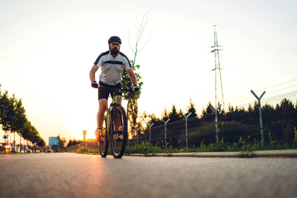 istock Cyclist is on the sunset road 1266144337