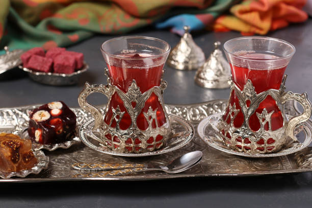 Pomegranate tea and turkish delight on metal tray on dark background, Closeup, Horizontal format