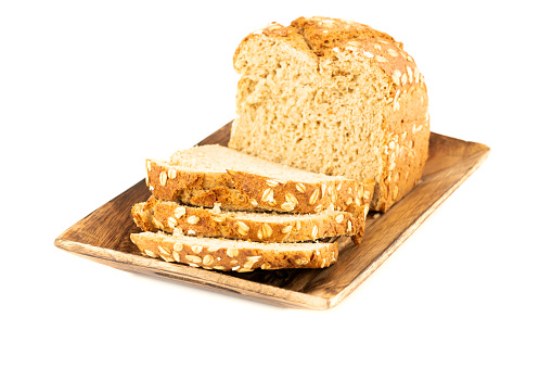 Wholegrain bread bun with oat on wooden tray isolated on white background.
