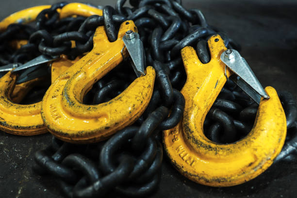istock Iron chains with hooks lie on the floor of the workshop. A device for loading and unloading goods. 1266147680