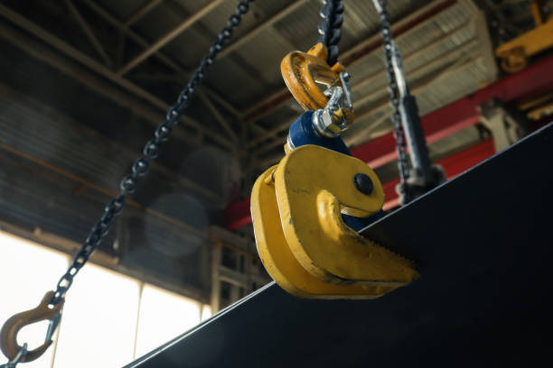 istock Unloading sheet metal in a factory using a workshop crane and sheet metal clamps. 1266147735