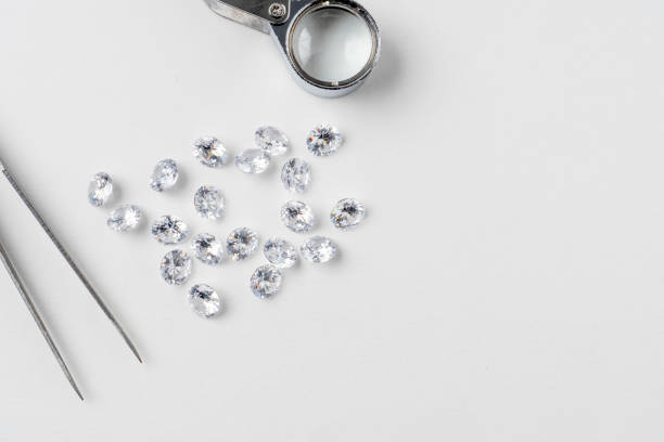istock top view brilliant cut diamond held by tweezers isplated on bwhite background 1266148997