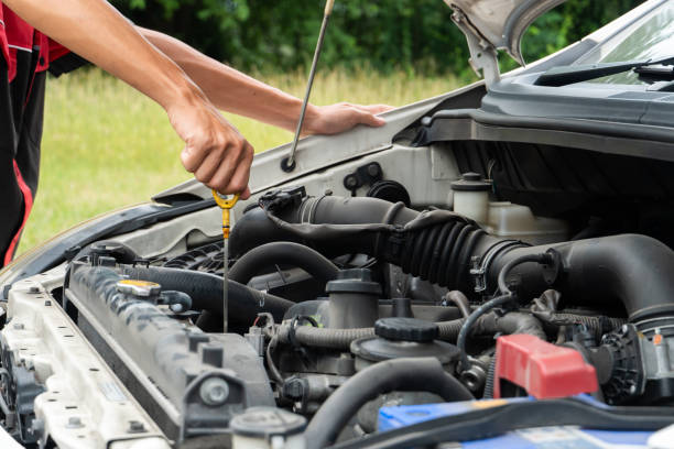 istock man checking the oil level in car engine 1266149202