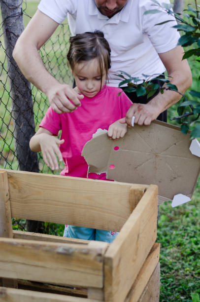 istock Father and daughter composting outdoors 1266151738