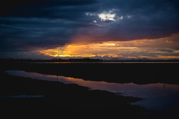 istock storm clouds over the water and sunset over the lake 1266155381