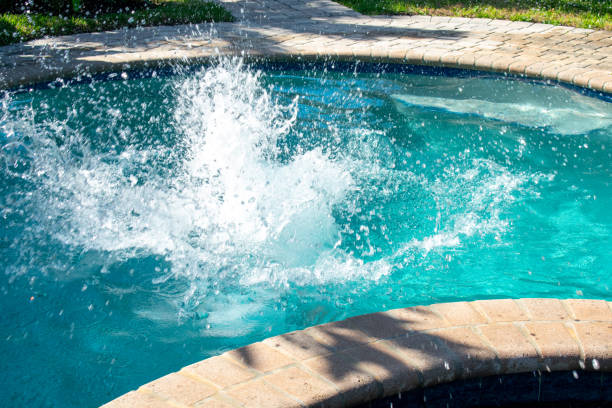 istock A Splash in a Pool Caused By a Boy Jumping Into the Water 1266155659