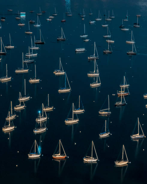 istock sailboats in a harbor at night 1266156888