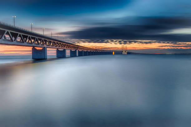 Oresund Bridge at sunset HDR image of oresund bridge at sunset. Colourful, smooth, side view of the bridge. long exposure. Malmo Sweden. oresund bridge stock pictures, royalty-free photos & images