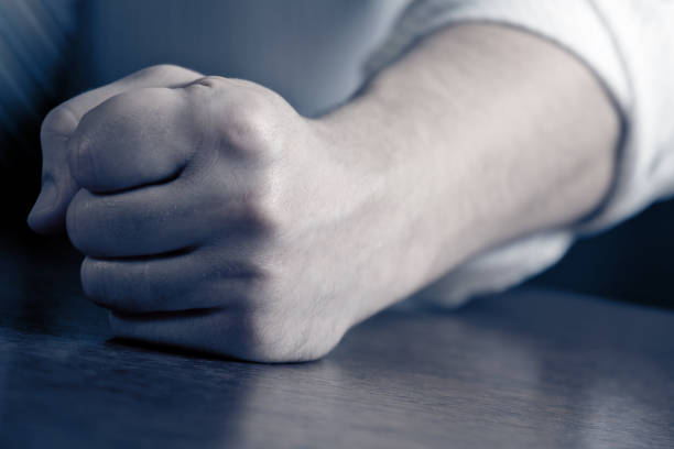 istock Man hitting desk with clenched fist 1266161584