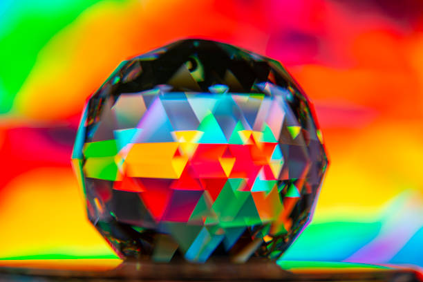 Abstract shot of glass ball on colorful holographic backdrop
