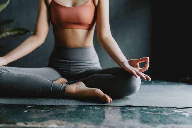 istock Anonymous Woman Doing Yoga at Home: Lotus Position 1266161771