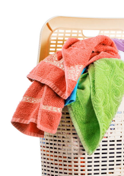 istock Laundry basket full of dirty washing (isolated on white) 1266161855
