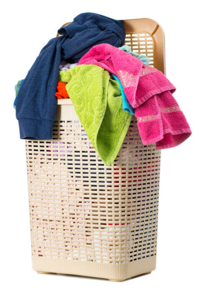 istock Laundry basket full of dirty washing (isolated on white) 1266161891
