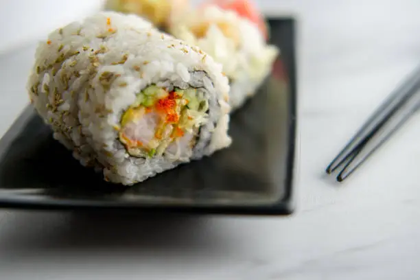 Fresh shrimp tempura sushi roll with wasabi and ginger