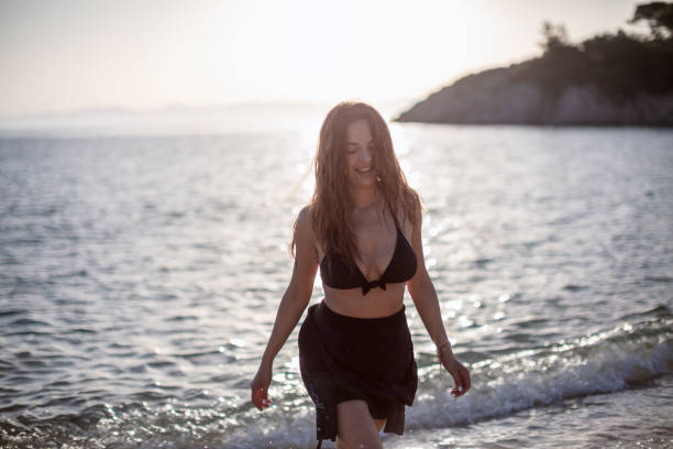 istock Young surfer woman at the beach 1266161976