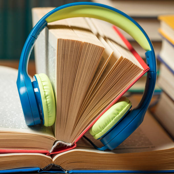 istock Audio book concept - headphones with books 1266162612