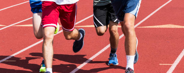 istock Legs of four boys running on a track 1266165407