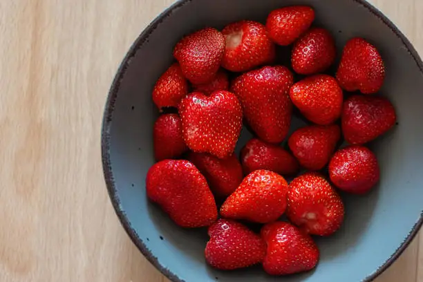 A bowl of fresh red strawberries with view from above