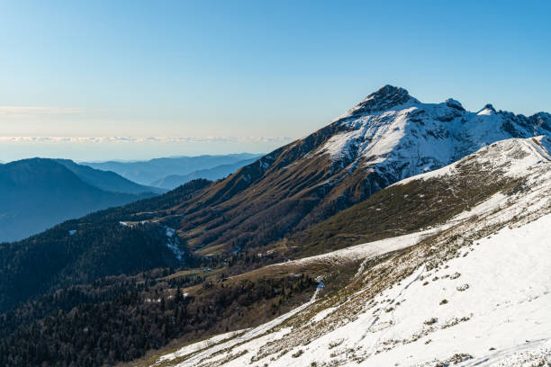 istock Alpine landscape with peaks covered by snow 1266167912
