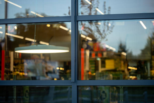 supermarket store windows with lights and advertisements inside. High quality photo