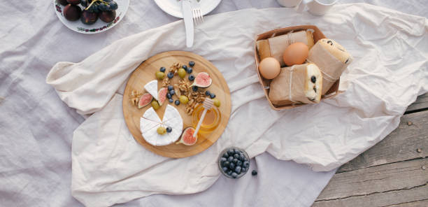 istock Picnic on the lake with fresh eggs, cheese and sandwiches. 1266169453