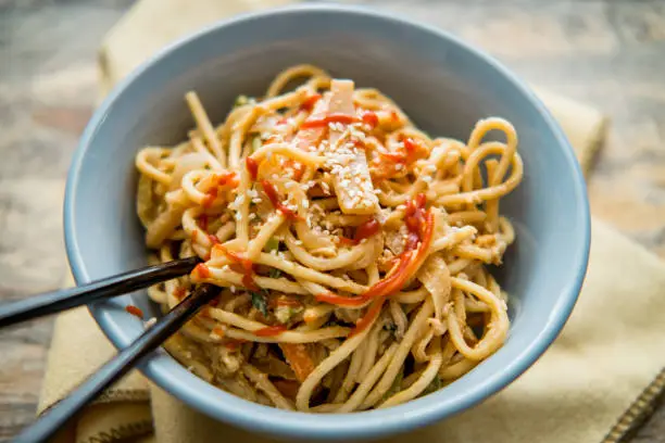 Spicy Thai vegetable peanut butter lo mein noodles with sesame seeds