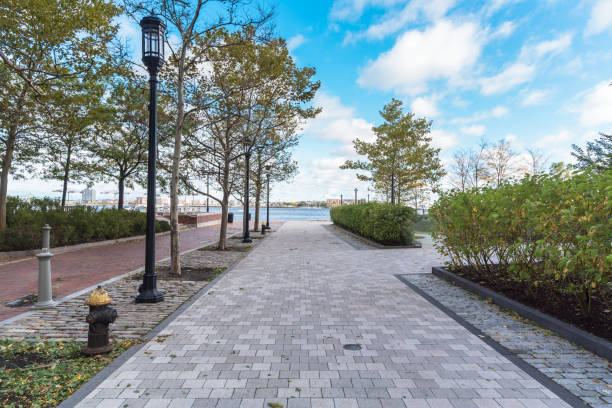istock Empty stone pedestrian street in a waterfront park on a clear autumn day 1266175909