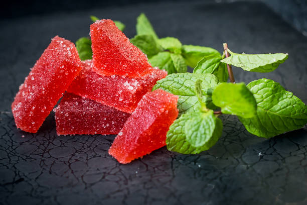 istock red jelly sweets on a dark background with mint leaves 1266177460
