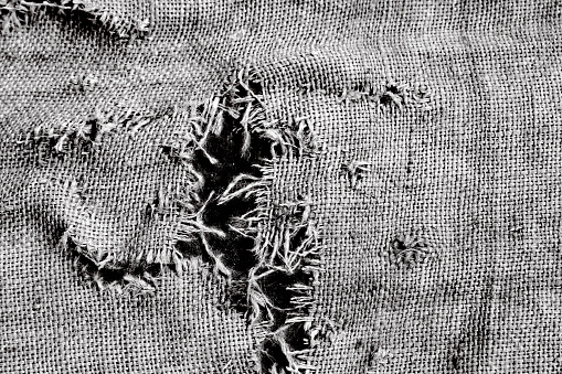 Black and white old damaged Sackcloth, abstract background with copy space, full frame horizontal composition