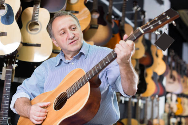 istock Man is playing on acoustic guitar 1266187414