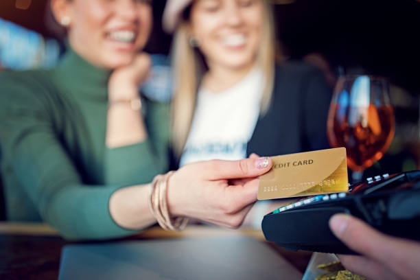 istock Girlfriends are paying using contactless credit card in the bar 1266187536