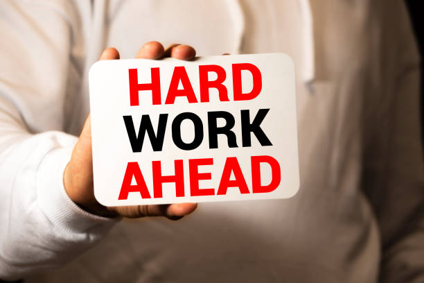 istock Word writing text HARD WORK AHEAD. Business concept for situation in which an employee works mainly from home Note paper taped to black computer screen near keyboard and stationary. 1266191771