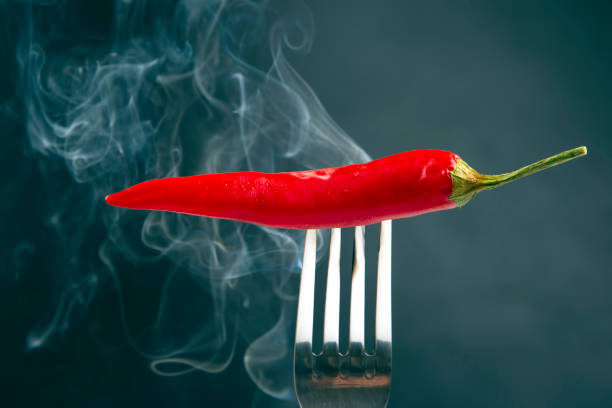 istock red hot peppers on a fork in real smoke. vegetative vitamin food 1266196732