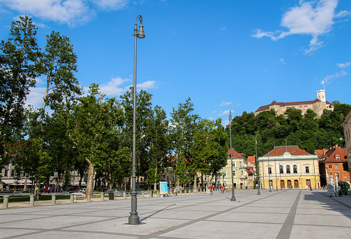 The park at Congress Square in the center of Ljubljana on a summers day, Slovenia, with the Slovenian Philharmonic Building in the background