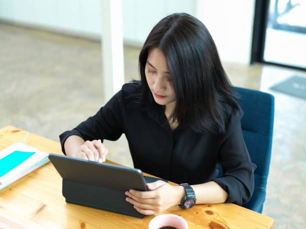 istock Female college student preparing her presentation on digital tablet 1266208501