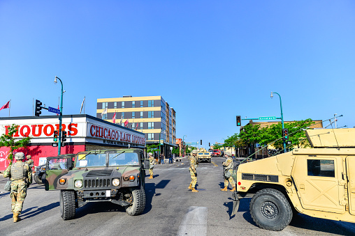 Minneapolis, MN, USA:  5/30/2020 - Damage in Minneapolis streets after protests and rioting occur. Fires still burning in distance after looting and rioting. Road was under construction already.