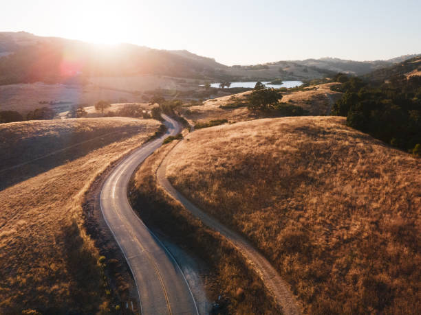 istock Windy Road in Valley during Sunset, Aerial View 1266211765