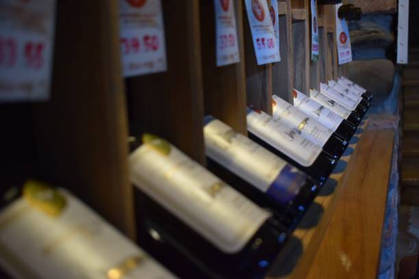 Wine bottles stacked in a winery.