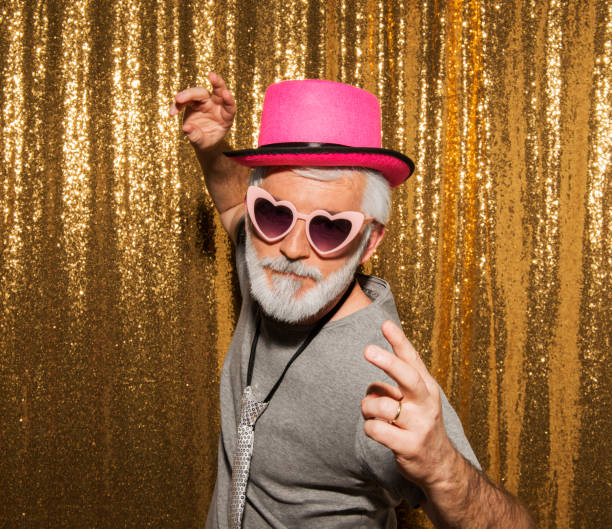 Senior man wearing props and gesturing during the party.