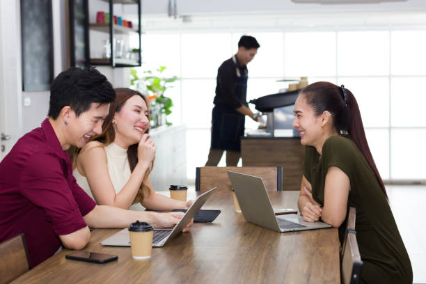 istock Group of young workers talking in a coffee shop. 1266214870