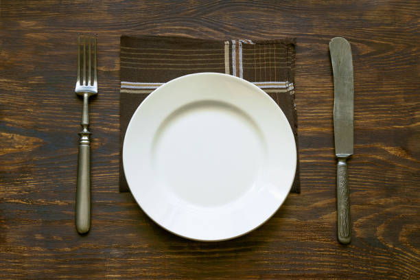 istock Cutlery, plate and napkin on the table 1266214911