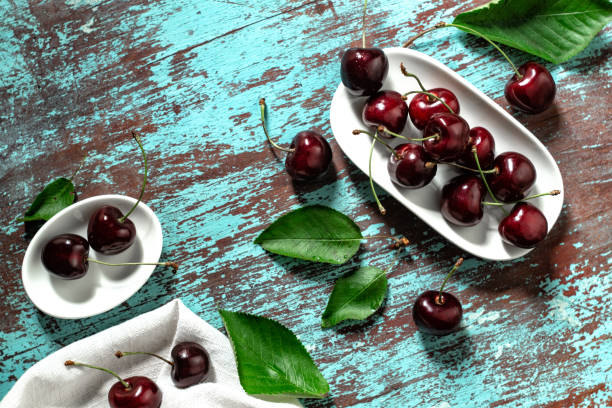 istock Ripe cherries on a white plate. Top view 1266216853