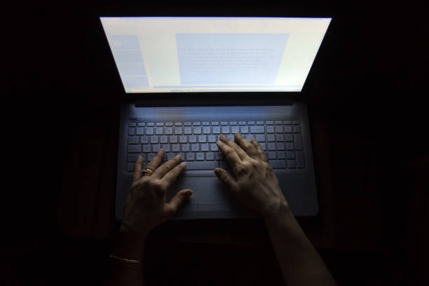 Female hands on a computer, working in the dark Female hands on a computer, working in the dark, at night causes much damage to the eyes indifference stock pictures, royalty-free photos & images