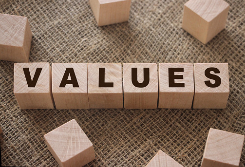 Values Word Written In Wooden Cubes on burlap background. Core values psychological concept.