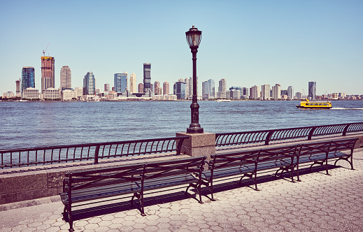 Jersey City skyline seen from downtown New York on a sunny summer day, retro color toned picture, USA.