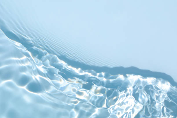 transparent blue colored clear calm water surface texture - wave flowing clean nature imagens e fotografias de stock