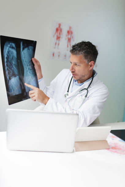 istock Doctor discusses X-ray image via video conference 1266223449