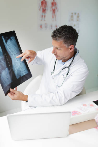 istock Doctor discusses X-ray image via video conference 1266223460