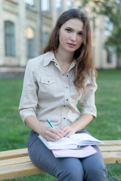 istock Young beautiful girl student in shirt 1266223581